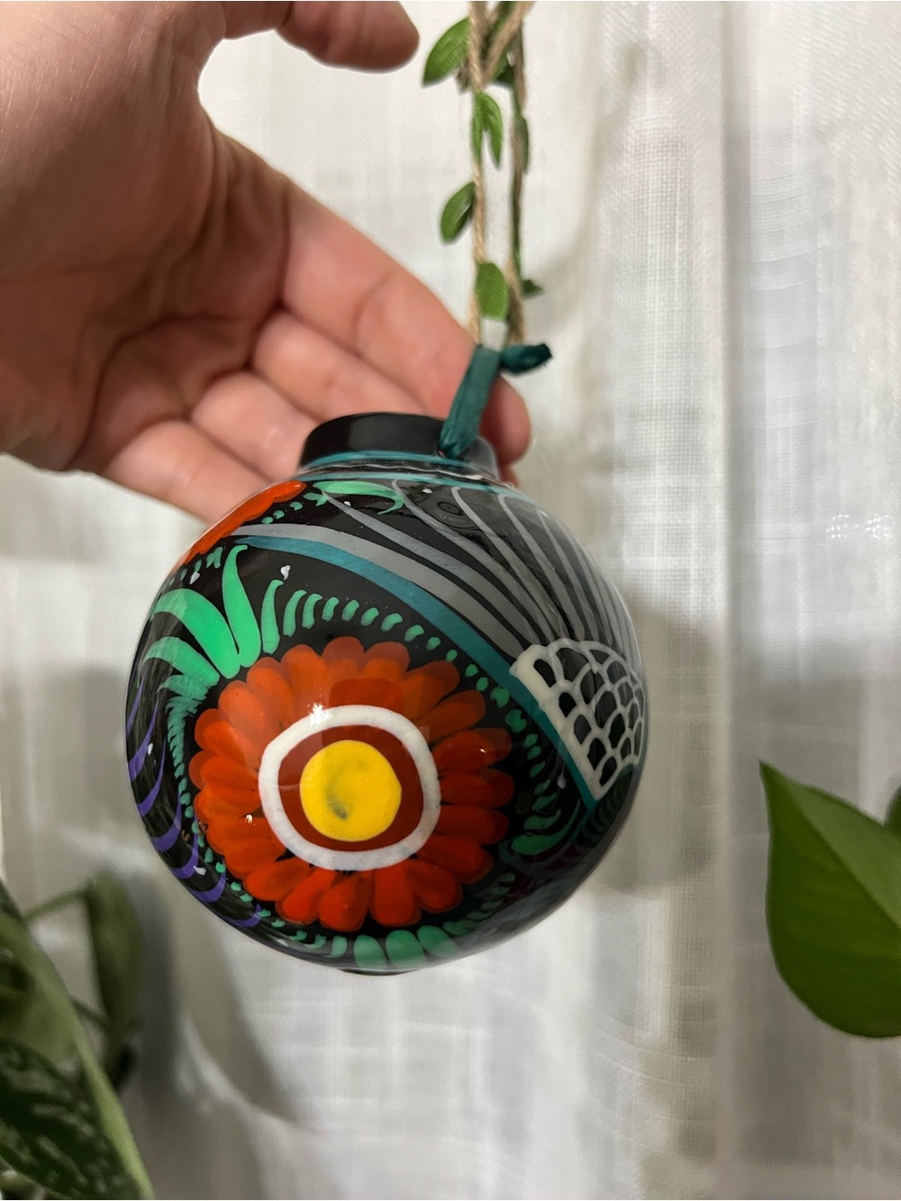 Hand-Painted Black Ceramic Orb Ornament with Red Floral Motif